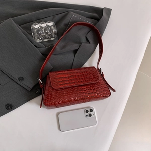 Fashionable burgundy crocodile pattern shoulder bag with silver buckle and phone for scale