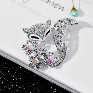 Detail shot of a crystal fox brooch with silver finish and colorful rhinestones