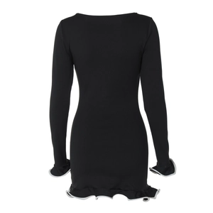 Detail view of the black long sleeve dress featuring white ruffle trim on the sleeves and hem