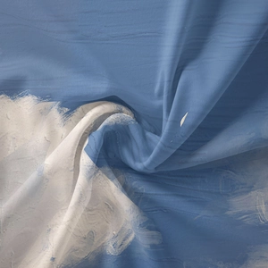 Detailed close-up showing the soft texture and blue abstract mandala print of the tapestry