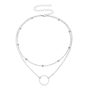 Detail of silver double layer chain necklace with round beads and circular ring pendant
