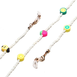 Detail of colorful fruit charms and white seed beads on glasses and mask chains