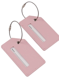 Set of two pink PU leather luggage tags with steel loops on white background
