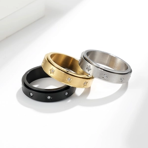 Detail of spinning rings in black, gold, and silver with brushed metal and star zircon