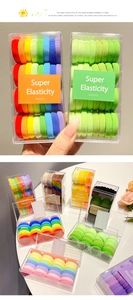 Detail of multi-colored high-elastic seamless hair ties in a clear rectangle storage box