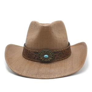 Detail of western cowboy straw hat featuring embossed leather band and turquoise concho