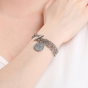 Detail of multi-layer stainless steel bracelet with coin pendant and OT toggle clasp