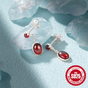 Elegant S925 sterling silver drop earrings featuring oval-cut red ruby gemstones