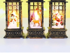 Detail of bronze Christmas lanterns featuring snowman and reindeer patterns with LED light