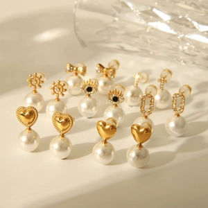 Macro view of gold bow and heart pearl earrings showing detailed craftsmanship and luster