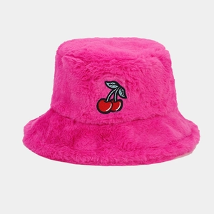 Detailed view of cherry embroidery on pink plush bucket hat with soft faux fur texture