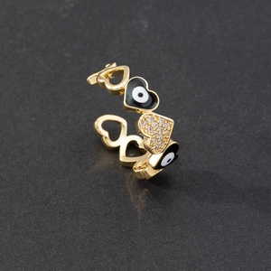 Detail of gold evil eye heart ring featuring black enamel and micro-pave cubic zirconia