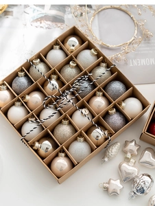 Close-up of 25 Christmas ball ornaments in gold, silver and beige in a craft gift box