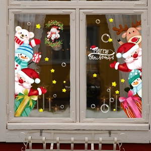 Festive Christmas window stickers with Santa, reindeer and snowman on a glass window