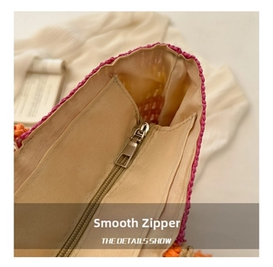 Detail view of colorful straw tote bag interior with smooth metal zipper and canvas lining