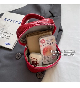 Macro view of red quilted mini bag interior with wallet and accessories storage