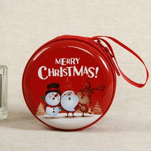 Close-up of a red round Christmas coin purse with a Santa cartoon and zipper closure