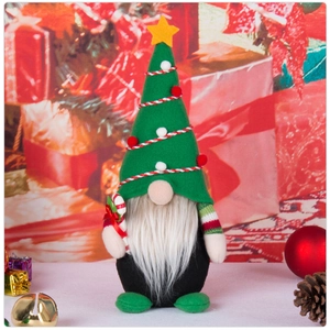 Detailed close-up of a Christmas gnome with a green star hat and candy cane decoration