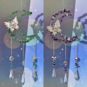 Detail of handmade moon suncatcher with crystals, metal butterfly, and prism pendants