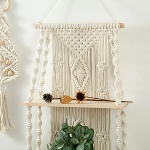Macro shot of hand-woven beige macrame texture and natural wood shelf detail