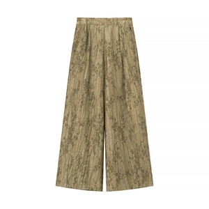 Detail of olive green jacquard wide-leg trousers with silk-like textured fabric