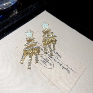 Detail of gold star Christmas tree earrings with blue stars and crystal tassels