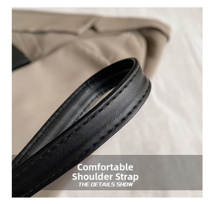 Detail of comfortable black faux leather shoulder strap with neat double stitching finish