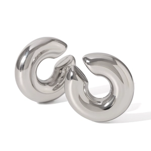 Close-up of polished silver hollow hoop earrings in minimalist chunky metal design