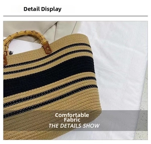 Detail shot of the tight cotton weave and retro bamboo handle on a striped tote bag