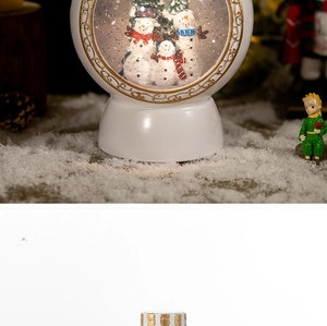 Macro detail of Christmas snow globe featuring three snowmen and a warm ceramic base