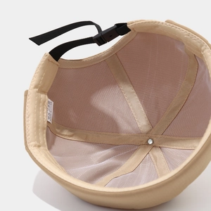 Detail of beige miki hat featuring breathable mesh lining and adjustable buckle strap