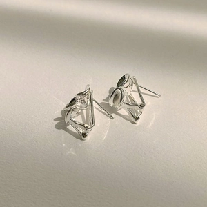 Macro shot of S925 sterling silver geometric stud earrings with polished finish