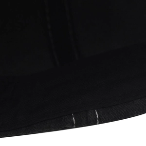 Detailed close-up of contrasting white double stitching on a black washed cotton baseball cap