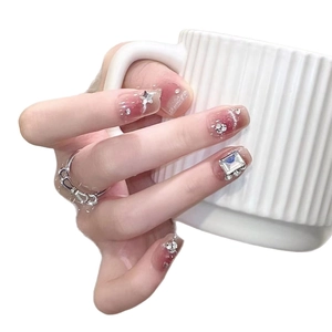Sweet pink gradient press-on nails with silver stars, crystals, and shiny rhinestones