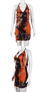 Detail of orange and black tie-dye halter dress with layered fringe and boho tassels