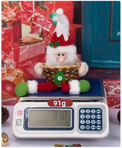 Close-up of Santa Claus plush candy basket with weight display at 91g for Christmas