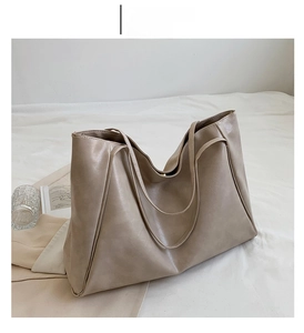 Detail view of large cream white tote bag in soft faux leather for casual daily commute