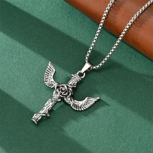 Detailed view of silver winged cross pendant with rose motif on a box chain link