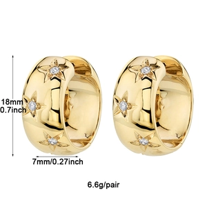 Detail shot of gold star-embossed earrings with 18mm diameter and zircon inlays