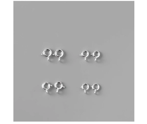 Detailed view of silver spring ring clasps in four sizes for DIY jewelry making