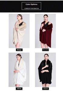 Detail view of winter knitted capes with faux fox fur collars in beige, red, white, and black