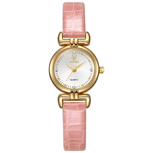Detailed view of pink leather strap and crystal-set dial on a rose gold quartz watch