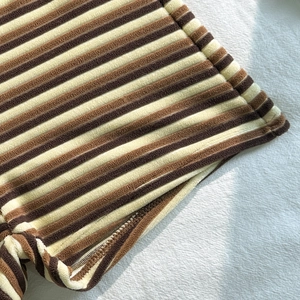 Close-up of striped towel fabric bikini with textured knit detail and stitching