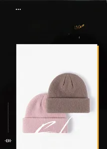 Detail of pink and brown ribbed knit beanies showing thick weave texture and fold-over cuff