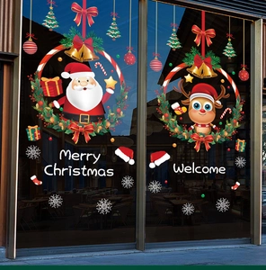 Detail of Santa Claus and reindeer window stickers on a glass door for Christmas decor