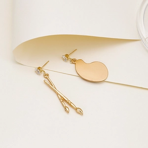 Artistic gold-tone palette and brush mismatched earrings with sparkling zircon stones
