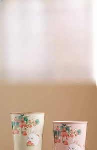 Detail of Ru kiln ceramic tea cup featuring cute rabbit and strawberry hand-painted motifs