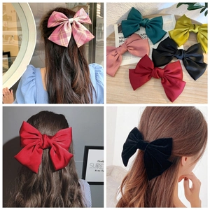 Oversized satin bow hair clips in various colors including red, pink and black for women