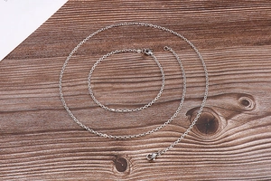 Detailed view of silver minimalist titanium steel thin chain necklace and bracelet set
