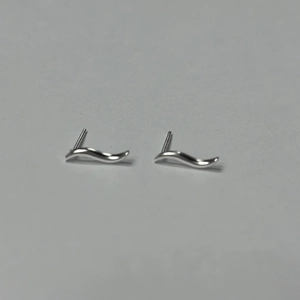 Detailed close-up of S925 sterling silver stud earrings featuring elegant S-shaped wave curves